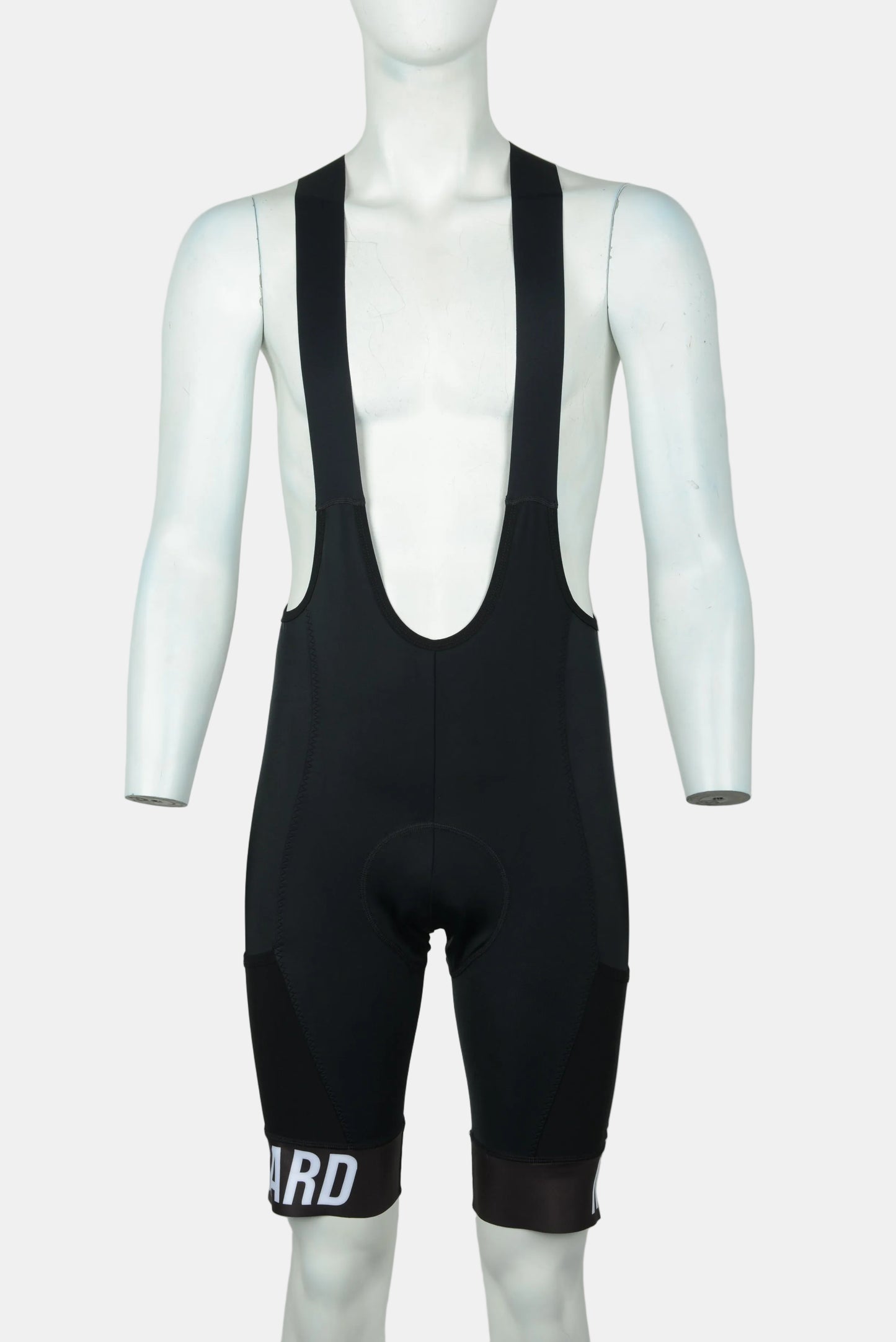 Black cycling bib shorts displayed on a white mannequin torso against a light gray background. The bib shorts feature a deep V-neck and a padded seat, with white text 'ARD' printed on the lower left leg.