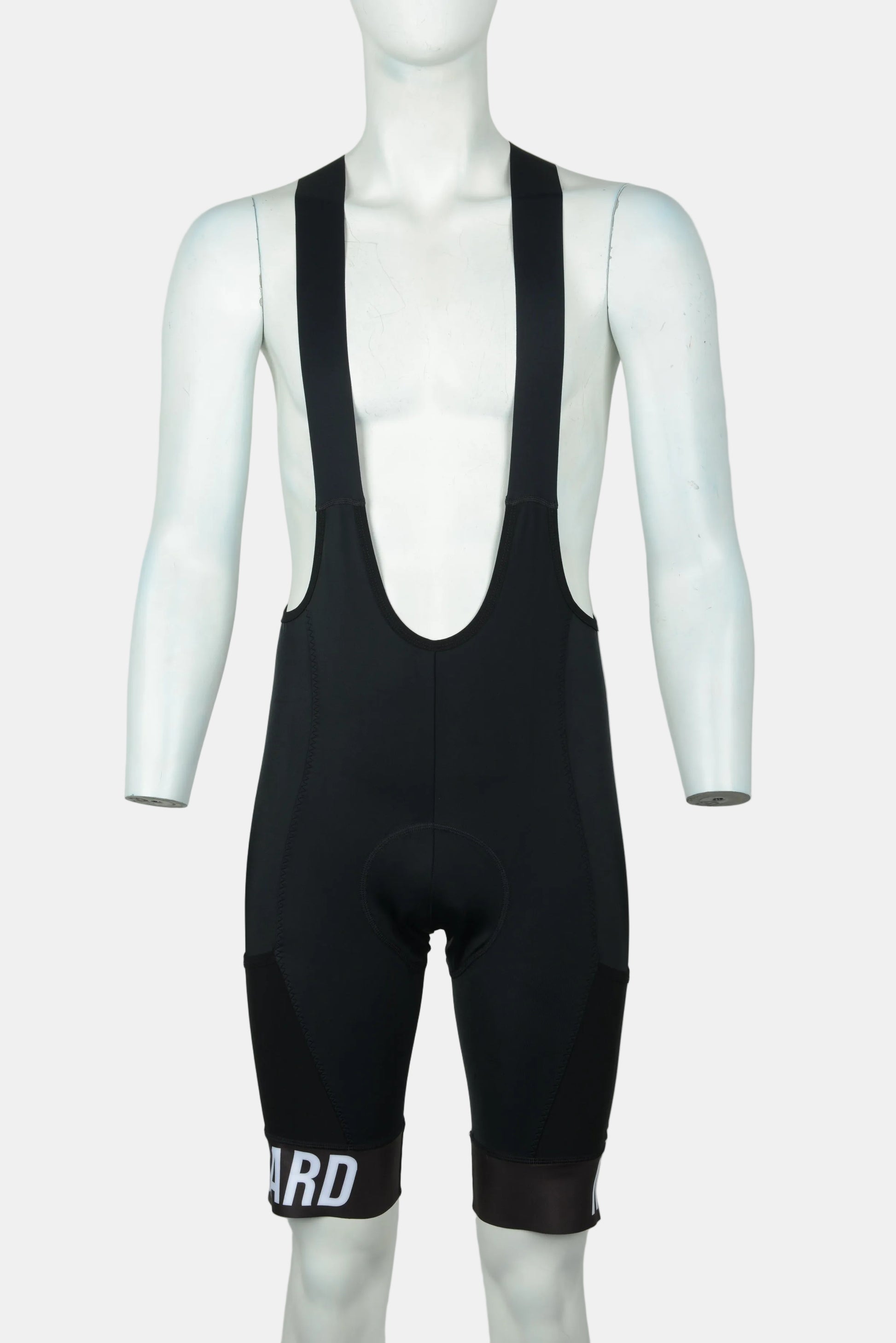 Black cycling bib shorts displayed on a white mannequin torso against a light gray background. The bib shorts feature a deep V-neck and a padded seat, with white text 'ARD' printed on the lower left leg.