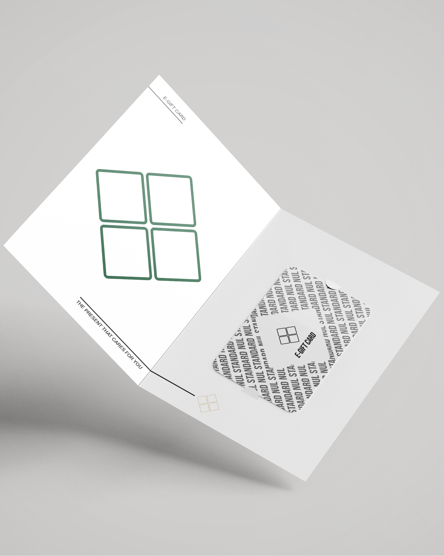An open white folding card or booklet shown at an angle on a light gray background. The left page has a green outlined four-square graphic, and the right page has a gray patterned square with small black text and a small logo.