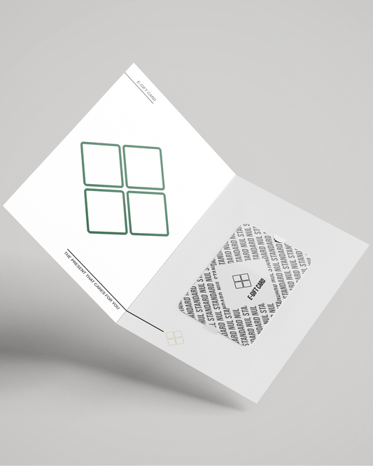 An open white folding card or booklet shown at an angle on a light gray background. The left page has a green outlined four-square graphic, and the right page has a gray patterned square with small black text and a small logo.