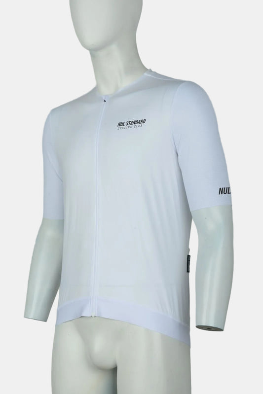 A white short-sleeve cycling jersey displayed on a white mannequin torso against a light gray studio background. The jersey has a full front zipper, a small black 'NUL STANDARD' logo on the left chest, and 'NUL' printed in black on the right sleeve.